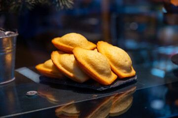 French sweet dessert pastry madeleine on display in french bakery