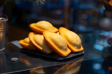 French sweet dessert pastry madeleine on display in french bakery