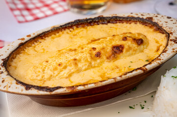 Quenelle, speciality of Lyon, oval-shaped dumplings filled with pike white fish served in creamy sauce in traditional Lyonnaise Bouchon, France