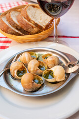 Starter dish in traditional restaurants on Burgundy, snails cooked with butter, garlic and herbs