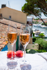 Summer party, drinking of French brut champagne sparkling wine in glasses in yacht harbour of Port Grimaud near Saint-Tropez, French Riviera vacation, France