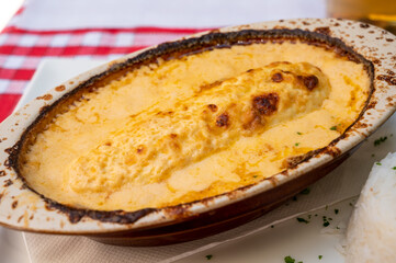 Quenelle, speciality of Lyon, oval-shaped dumplings filled with pike white fish served in creamy sauce in traditional Lyonnaise Bouchon, France