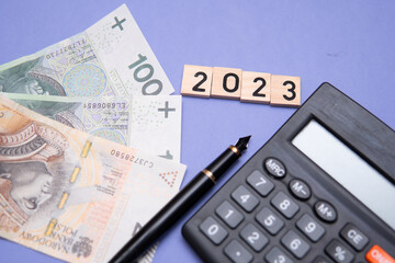 the inscription 2023 next to Polish money. A concept showing business goals and challenges for 2023