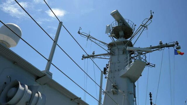 Image of  a military radar air surveillance on navy ship tower.