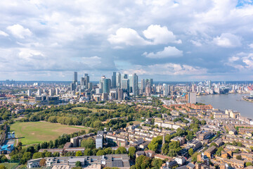 London, the city on the river bank, with residential buildings, green areas, and modern skyscrapers, aerial view.