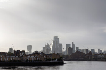 London dockland housing on the River Thames waterfront and modern business buildings in the...