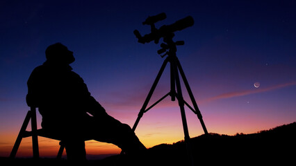 Man with astronomy telescope looking at the night sky, stars, planets, Moon and shooting stars.