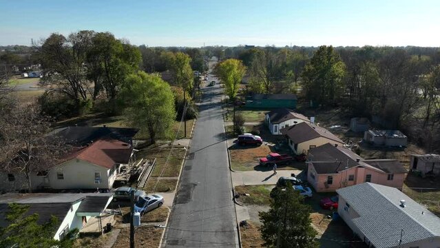 Rising aerial of small single story homes in Rural Deep South. Rising aerial during day. Low income poverty area on outskirts of city.