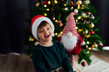 Fototapeta na wymiar Happy child with Santa Claus hat laughing