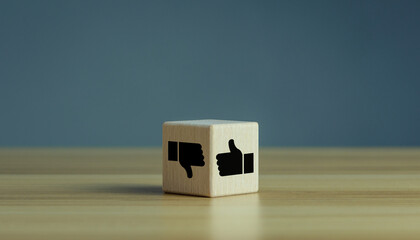Wooden cube with Thumbs up down hands agree and disagree gesture, Like and dislike symbol, positive...