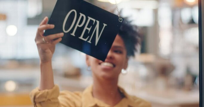 Small Business owner woman in apron turning open sign on door smiling welcoming clients to new cafe restaurant. Entrepreneur Service hospitality. High quality 4k footage