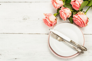 Romantic dinner table on white wooden background. Love concept for Valentine's or Mother's day