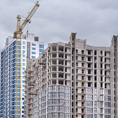 Half completed residential building, building under construction. Construction of new modern residential building. insulation work, glazing windows external wall insulation. Half finished building