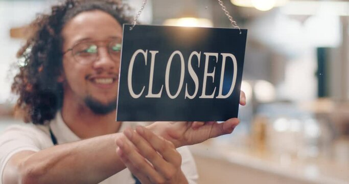 Coffee shop, cafe and small business with a startup entrepreneur hanging a closed sign on the window of his store. Bankruptcy, failure and recession with an economy in a financial crisis or crash