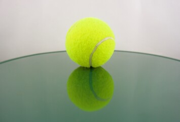 Tennis ball reflected in green tones
