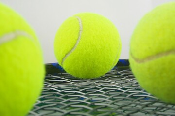 Tennis ball on a tennis racquet in macro view