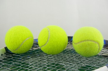 Tennis ball on a tennis racquet in macro view