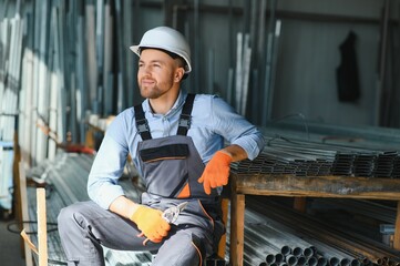 Profesional fabric worker. Metal processing plant. A worker at a metal profile warehouse.