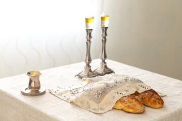 Shabbat image - silver candlesticks Lightened with olive oil, Silver kiddush cup and challah