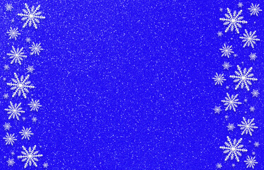 Winter blue aquamarine saturated bright background with random snowflakes two sideways. Christmas, New Year card with copy space.