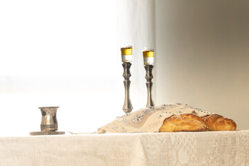 Shabbat image - silver candlesticks Lightened with olive oil, Silver kiddush cup and challah