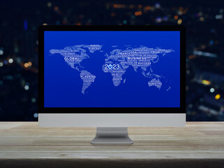 Start up business icon with global words world map on computer screen on table over night city tower, Happy new year 2023 global business start up online, Elements of this image furnished by NASA
