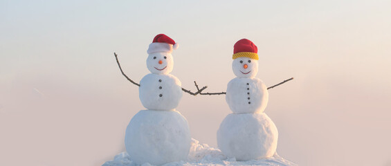 Snowman couple on the snow outdoor background. Christmas banner with snowman. New year greeting card with with snowman.