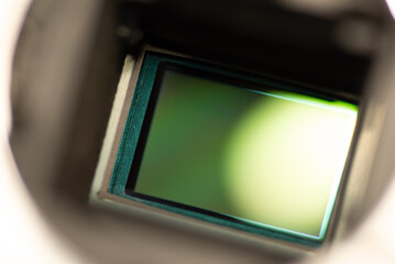 Close up shot of APC-S camera sensor. Clean sensor of DSLR camera exposed with flipped mirror