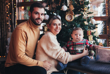 Naklejka na ściany i meble family near christmas tree