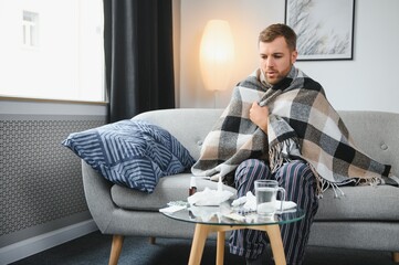 It's cold at home in wintertime. Man freezing in his house in winter because of broken thermostat....