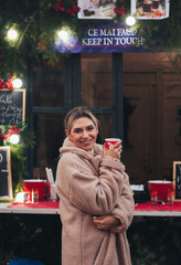 women at the christmas market with a drink