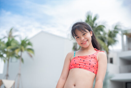 Happy girl enjoying summer vacations in a pool. Summer holidays, children's swimming, Pool woman on holidays in tropical resort swimming. summer vacation concept.