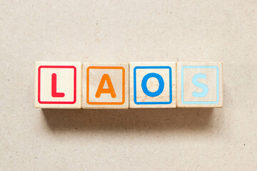 Color letter block in word laos on wood background