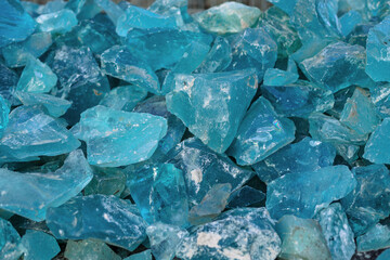 Many different decorative aquamarine crystal stone for decoration in landscape design.