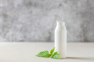 Obraz na płótnie Canvas Natural cosmetics with nettle leaves. Moisturizer organic cream