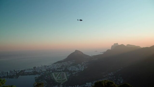 helicopter over the brazilian city of rio de janeiro in sunset