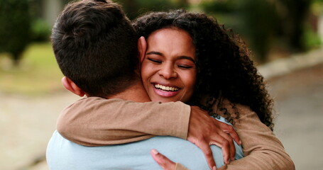 Black woman running and embracing man. Joyful girl hugging boyfriend