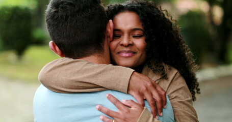 Beautiful African woman embracing boyfriend, loving caring relationship