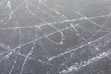 Frozen lake ice with ice skate tracks