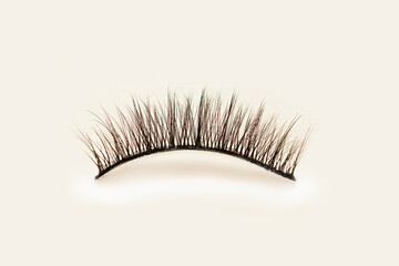 Pavers eyelashes on yellow background. Female cosmetics. Extension and lengthening of eyelashes.