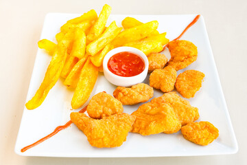 Fried Chicken breast hot crispy strips crunchy chicken tenders  isolated on white background.Nuggets isolated on white background on a plate