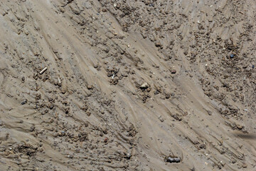 Dirty washed dirt road with traces of water flow in spring. Off-road