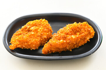 Fried Chicken breast hot crispy strips crunchy chicken tenders  isolated on white background.Nuggets isolated on white background on a plate