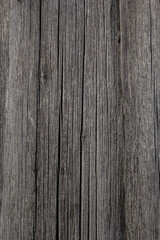 Old brown wood background made of dark natural wood in grunge style. The view from the top. Natural raw planed texture of coniferous pine. The surface of the table to shoot flat lay