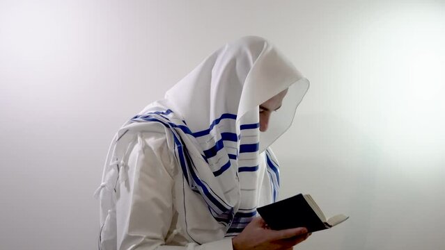 Religious jew in a tallit prays with a siddur in his hand. Judaism and jewish traditions (139)