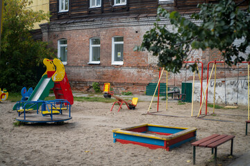 Childrens playground in Tomsk, Siberia, Russia with slide, sandbox, bench, swing, see-saw