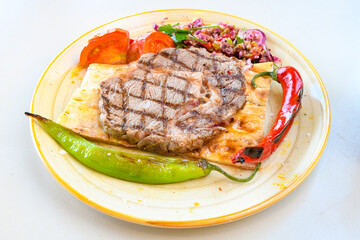 Beef steak grill with rice pilaf, fried potatoes, grilled pepper and tomatoes.Mix Platter with Beef rips, Cutlets, Potatoes and Sauces.