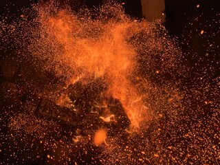 The fire burns in the dark, close-up. Concept: heat, light in darkness, high temperature Red flames...