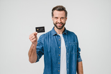 Smiling caucasian man bank client customer showing credit card for e-commerce, pay cashback, loan,...