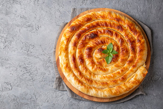 Traditional Turkish pastry with spinach. (Turkish Name: Ispanakli Kol Boregi, Bosnak boregi). Handmade pastry with spinach filling.
